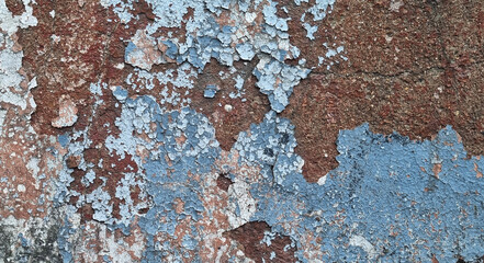 Texture of old rustic wall covered with gray and blue stucco. Multilayers of old paint on the wall....