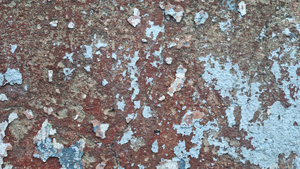 Texture of old rustic wall covered with gray and blue stucco. Multilayers of old paint on the wall. Textured background. Selective focus