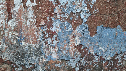 Texture of old rustic wall covered with gray and blue stucco. Multilayers of old paint on the wall....