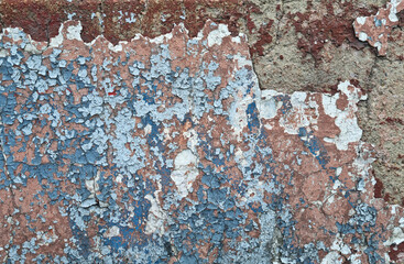 Texture of old rustic wall covered with gray and blue stucco. Multilayers of old paint on the wall....