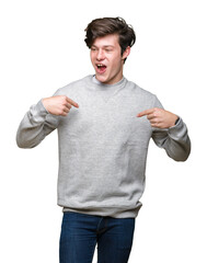 Young handsome sporty man wearing sweatshirt over isolated background looking confident with smile on face, pointing oneself with fingers proud and happy.