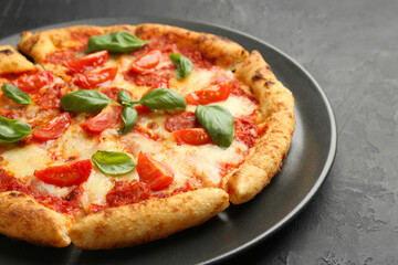 Delicious Margherita pizza on black table, closeup