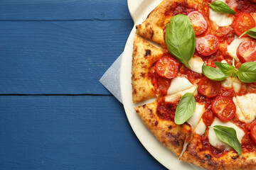 Delicious Margherita pizza on blue wooden table, top view. Space for text