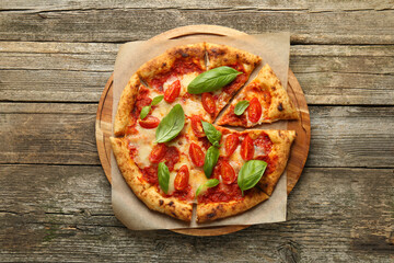 Delicious Margherita pizza on wooden table, top view