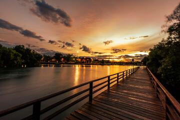 Close-up view of the natural background of the wooden bridge, which is surrounded by mangrove forests, colorful leaves of the leaves, blown through the blurred coolness during ecological travel.