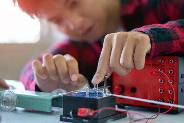 Children are studying the measurement of friction force with a spring balance using a small...