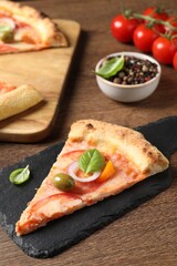 Slice of delicious vegetarian pizza on wooden table, closeup