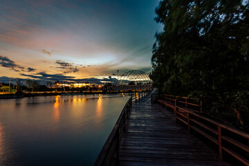 Fototapeta premium Close-up view of the natural background of the wooden bridge, which is surrounded by mangrove forests, colorful leaves of the leaves, blown through the blurred coolness during ecological travel.