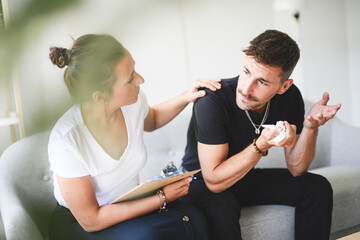Man with psychologist theraphy social problems concept drug addiction talk to a psychological woman