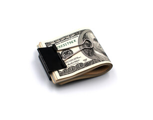 Rolled one hundred dollar bills clamped with a metal clip on a white background.