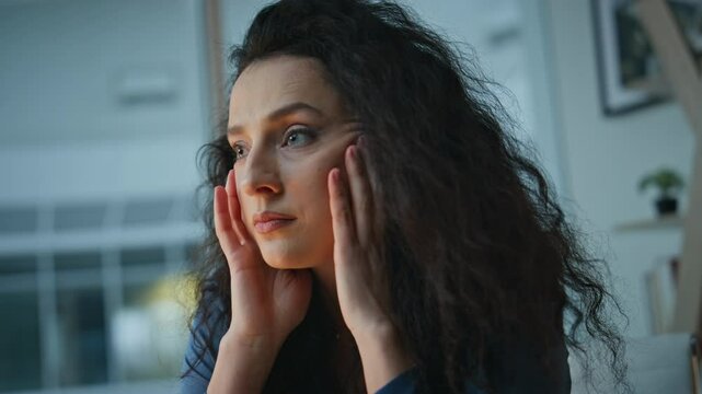 Stressed woman holding face in office closeup. Frustrated lady thinking problems