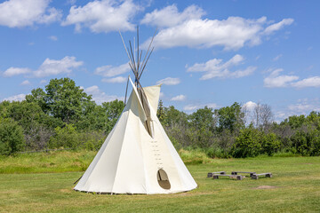 Tipi tent in front of woods