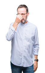 Middle age hoary senior man wearing glasses over isolated background tired rubbing nose and eyes feeling fatigue and headache. Stress and frustration concept.