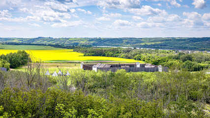 Fort Carlton Provincial Historic Site with blooming canola field