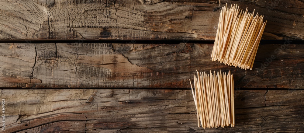 Poster Wooden background with disposable toothpicks and holder arranged in a flat lay composition, featuring ample space for text in the image.