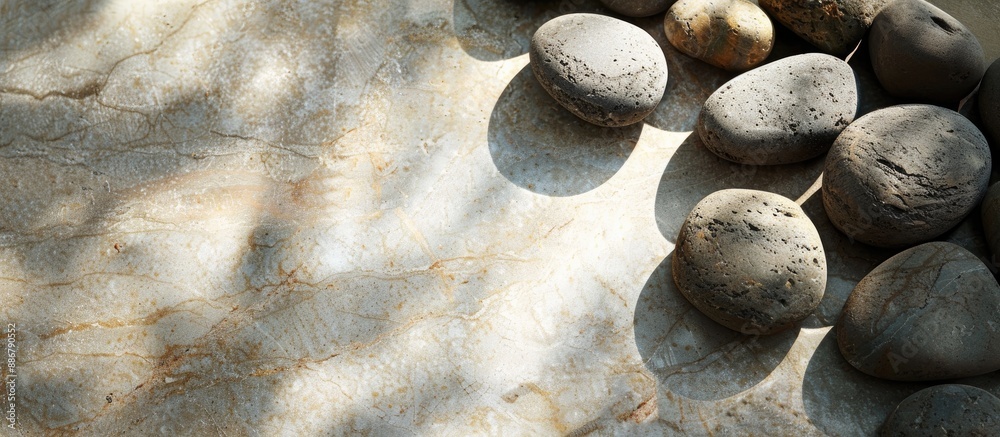 Aufkleber granite stones arranged on a beige surface with shadows, suitable for copy space image.
