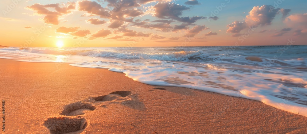 Poster sunrise beach with a visible footprint in the sand, offering an idyllic and serene scene with copy s