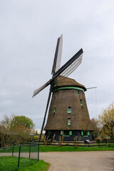 historic windmill as Pumping station at the confluence of two drainage canals in the Netherlands near Schagen