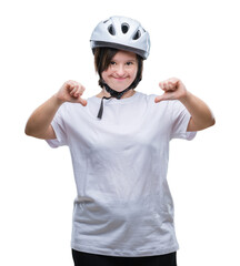 Young adult cyclist woman with down syndrome wearing safety helmet over isolated background looking confident with smile on face, pointing oneself with fingers proud and happy.