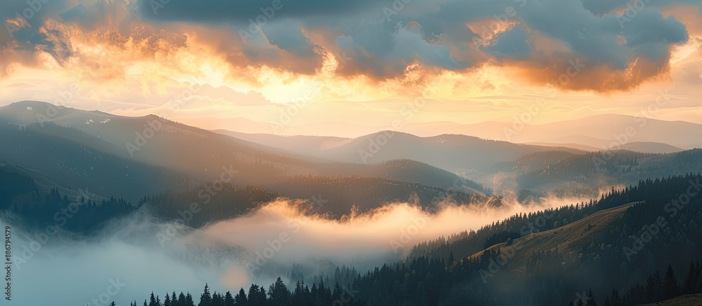 Poster A stunning sunrise in the mountains with a large fog floating over the high mountain scenery, creating a captivating copy space image.