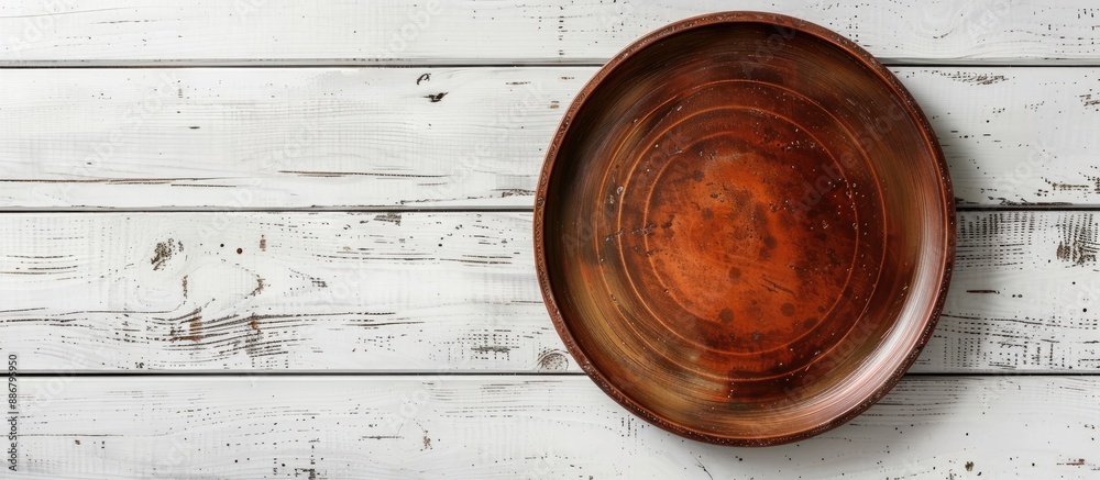 Aufkleber empty brown plate on white wooden table with ample copy space image.