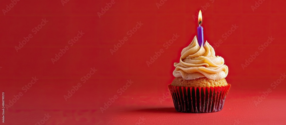 Poster a caramel cupcake topped with a lone purple candle displayed against a red background, providing amp