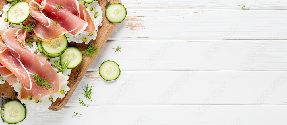 Poster Copy space image: Prosciutto and cucumber on rice cakes on a white wooden table, top view, suitable for adding text.