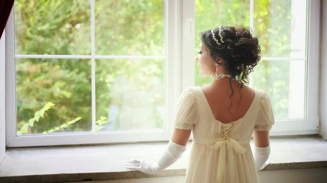 Retro woman looking out window, waiting for love. Fantasy fairy sexy lady Happy Princess girl, white silk vintage long dress old style ball gown, high bun black hair hairstyle back rear view. art 4k
