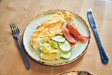 Ketogenic diet breakfast, omelette, salmon, avocado and cucumber close-up with space to copy. High quality photo