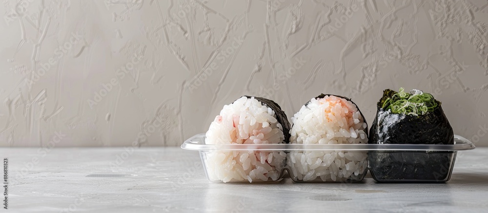 Aufkleber Japanese Onigiri set displayed in a transparent plastic container with a blank space for additional images.