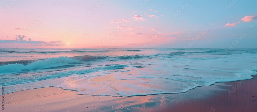 Poster Seascape with a serene beach at sunset. The horizon filled with a blend of blue and pink hues, creating a tranquil setting for the copy space image.