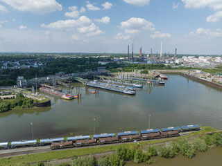 Inland transportation vessels of chemical products in the port at chemical production facility. Rodenkirchen, Germany.