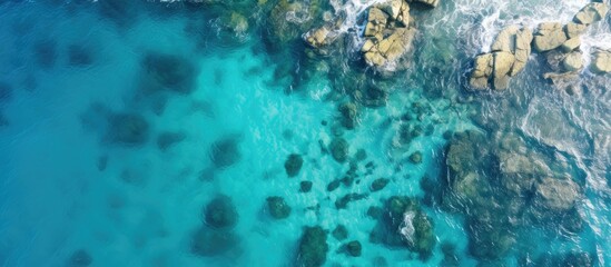 Scenic aerial shot of a serene blue ocean with rocky coastline, set against a stunning backdrop of natural beauty, suitable for a copy space image.