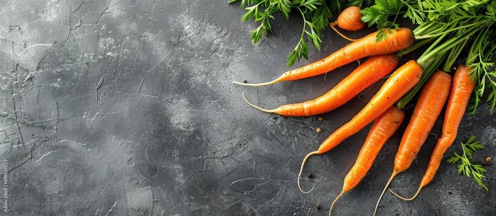 Poster a healthy eating concept featuring fresh carrots on a gray background, creating a frame of vegetable