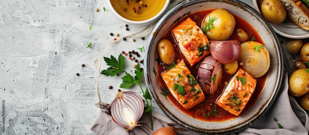 Poster salmon dish marinated with onion, served with bread and boiled potatoes, all against a simple backgr