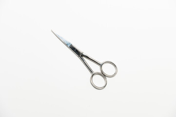metal manicure scissors on a white background. close-up of personal nail hygiene tool