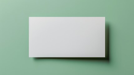 Fototapeta premium White paper sheet on green background with space for ads