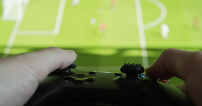 Gamer Playing Football Video Game On a Console Device - Close Up On Gamepad Controller
