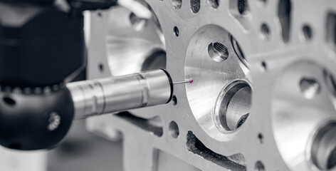Quality control of drilling CMM in car engine. Milling CNC machinery with coordinate measuring machine for automotive parts industrial