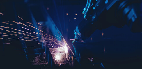 Laser CNC cut of metal with light spark. Blue color background banner, technology modern industrial