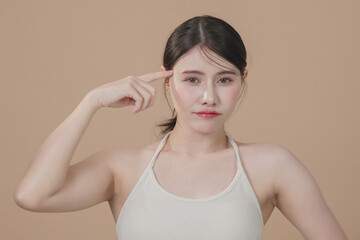 Fototapeta premium Beautiful young asian woman with clean fresh skin on beige background, Face care, Facial treatment, Cosmetology, beauty and spa, Asian women portrait. 