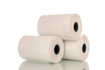 Three rolls of paper cash register tape, close-up isolated on white.