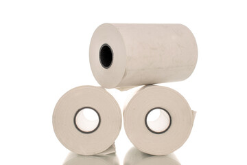 Three rolls of paper cash register tape, close-up isolated on white.