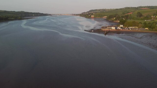 A drone view of the estuary of the River Teign, shot at Coombe Cellars, near Newton Abbot, with the seaside town of Teignmouth in the distance, Devon, England, United Kingdom, Europe