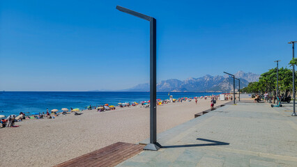 A beach full of people on a hot summer day