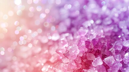 Fototapeta premium A tight shot of pink and purple crystals against a white and pink backdrop, with a softly blurred light source in the background