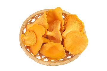 Chanterelle mushrooms in a wicker basket isolated on a white background. Top view. Flat lay