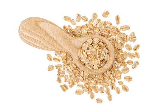 Oat flakes in wooden spoon isolated on white background with full depth of field. Top view. Flat lay