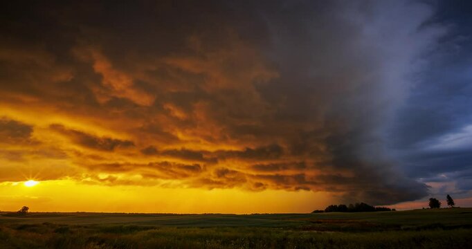 Shelf cloud from a supercell illuminated by golden light of sunset