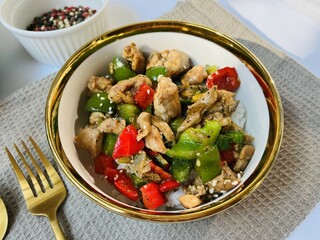 Black pepper chicken is stir-fried chicken breast with black pepper, paprika, garlic, onion and ginger. Served with rice on a bowl. Perfect for recipe, article, catalogue, or any cooking contents.